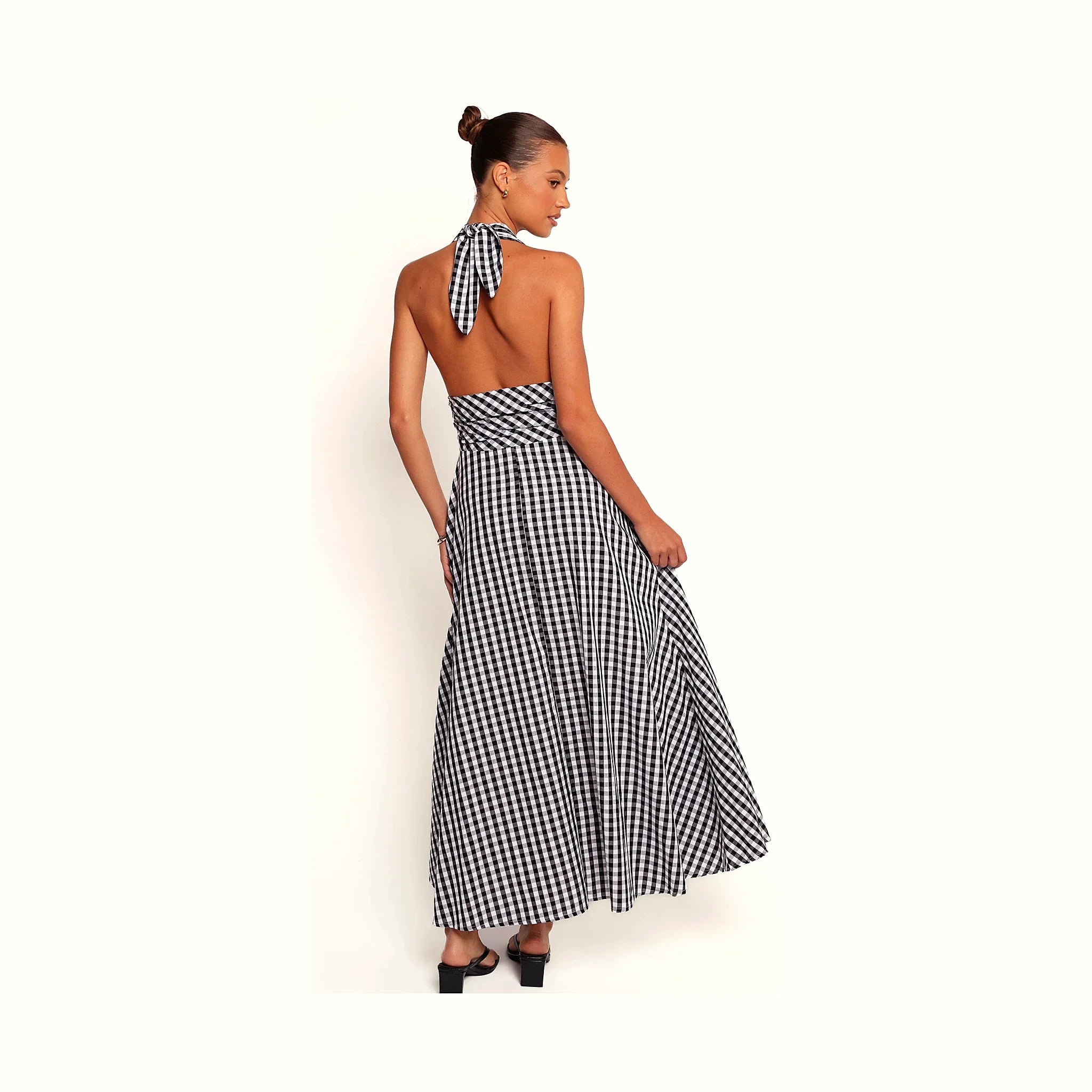 A black and white gingham halterneck maxi dress, photographed full length.