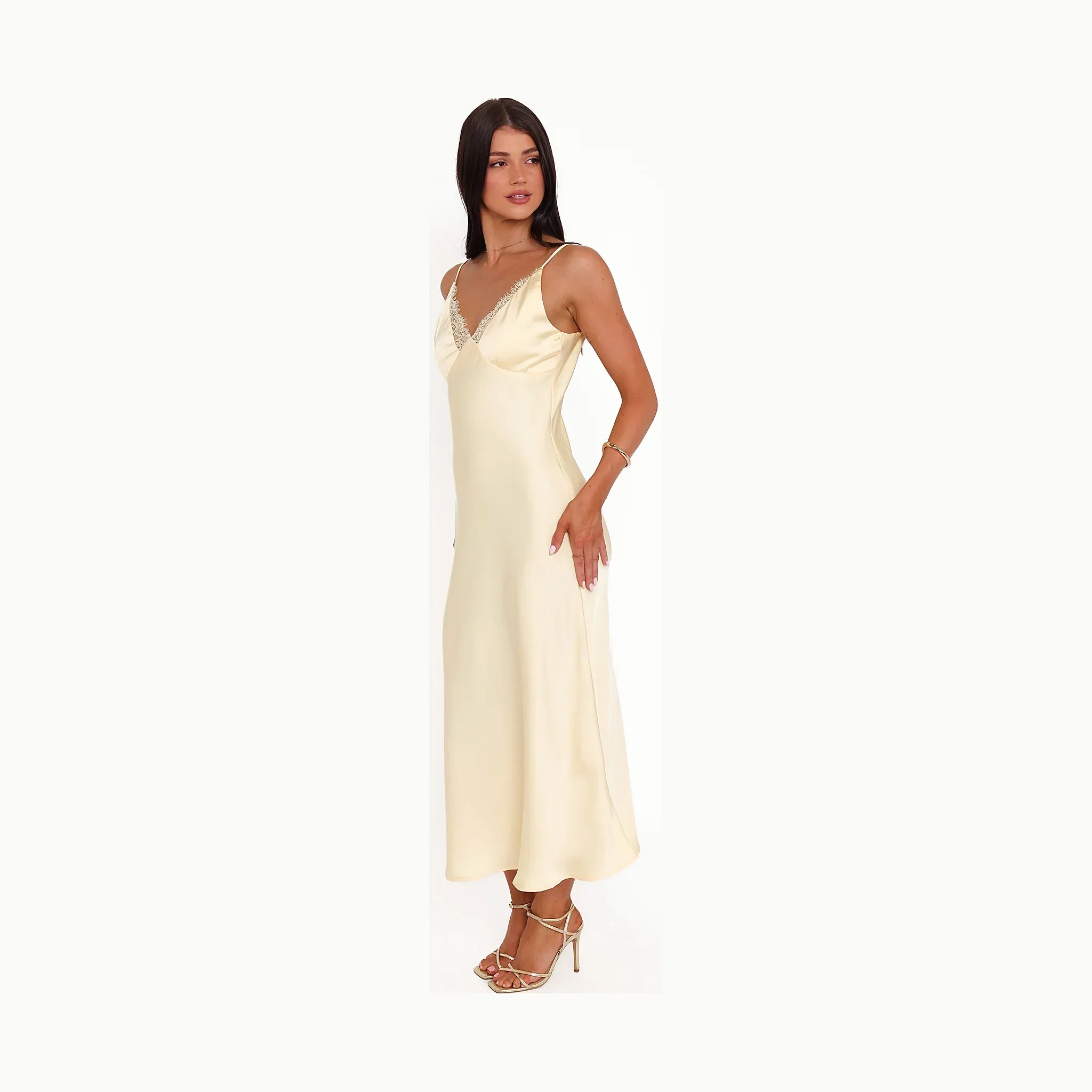 A butter yellow satin midi slip dress, photographed full length.