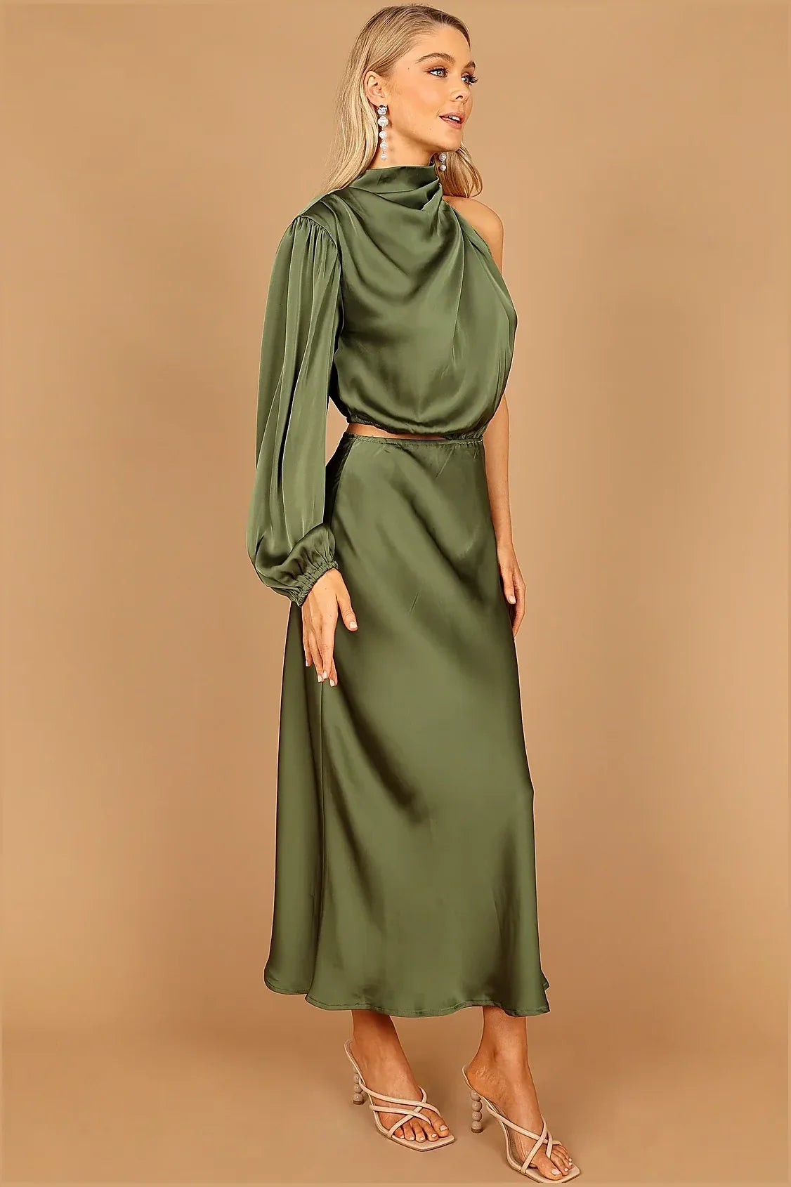 One-sleeved green dress with gathered pleated detail at the neckline