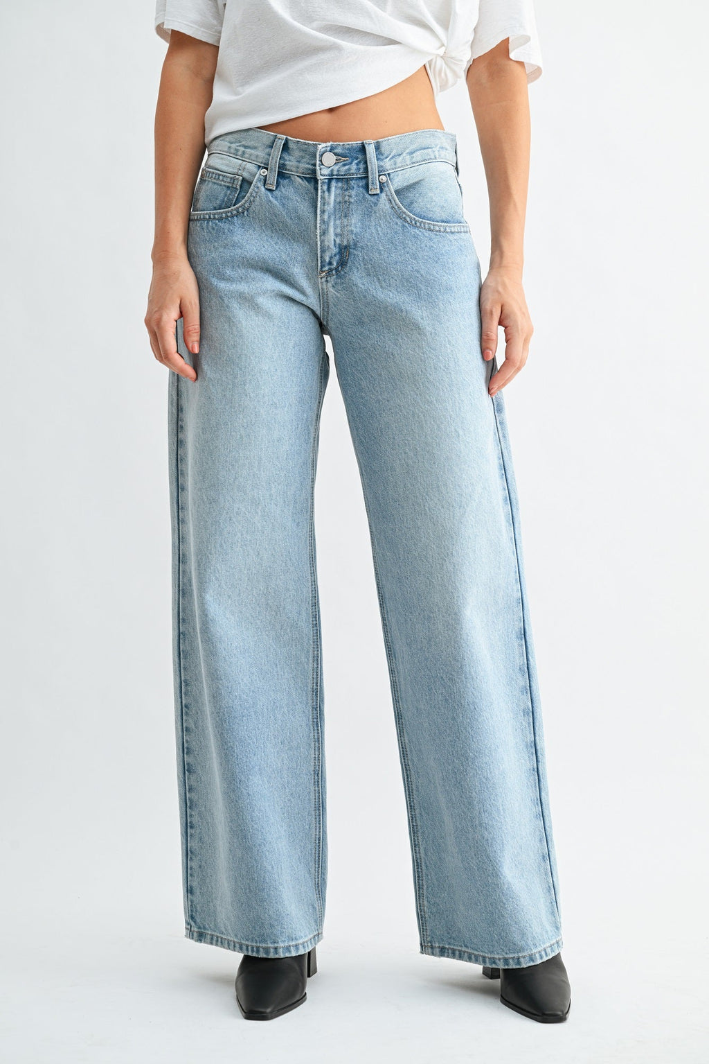 Minimal detailing on a street-style black wide-leg jean
