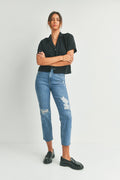 Ripped knee detailing on a black straight leg jean