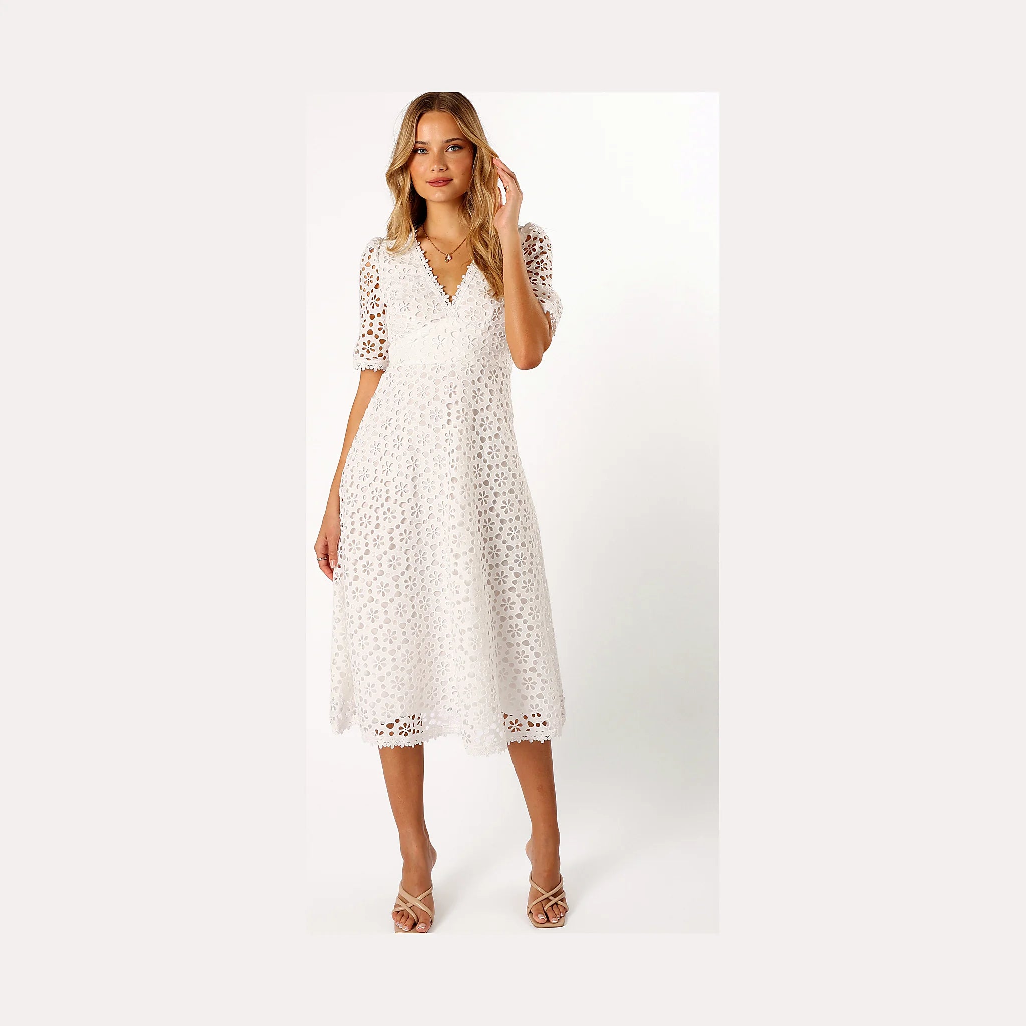 White dress with cut-out embroidery worked into the fabric
