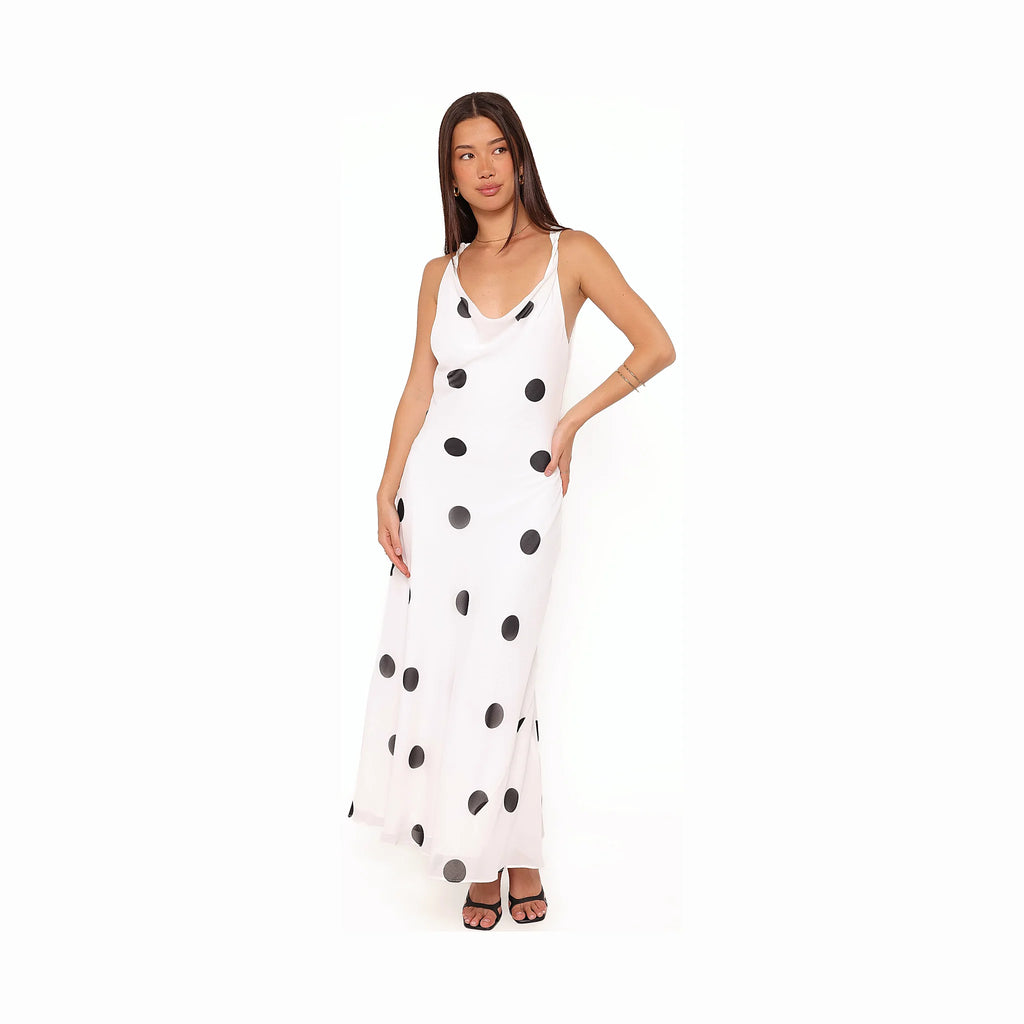 Long white dress with dark spots across a white ground