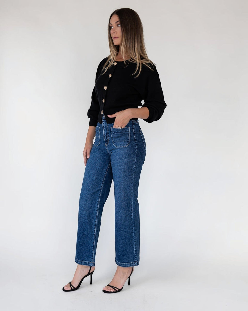 Ribbed cuff and hem finish on a black sweater knit cardigan