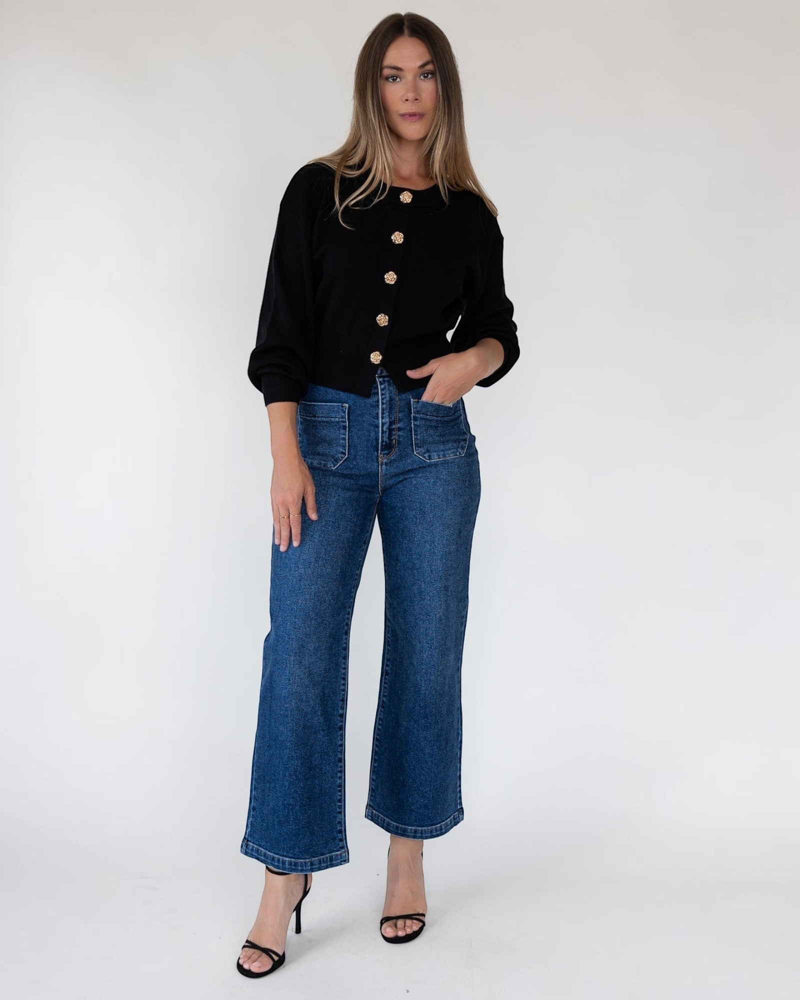 Soft stretch black sweater knit with a statement button front