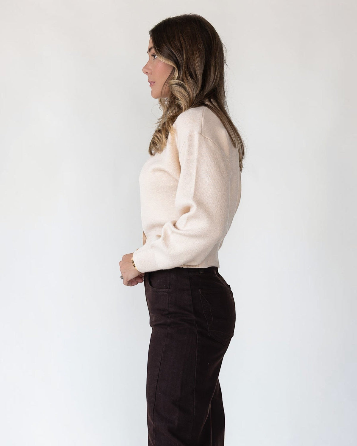 Ribbed cuffs finishing the long sleeves of a cream sweater knit cardigan