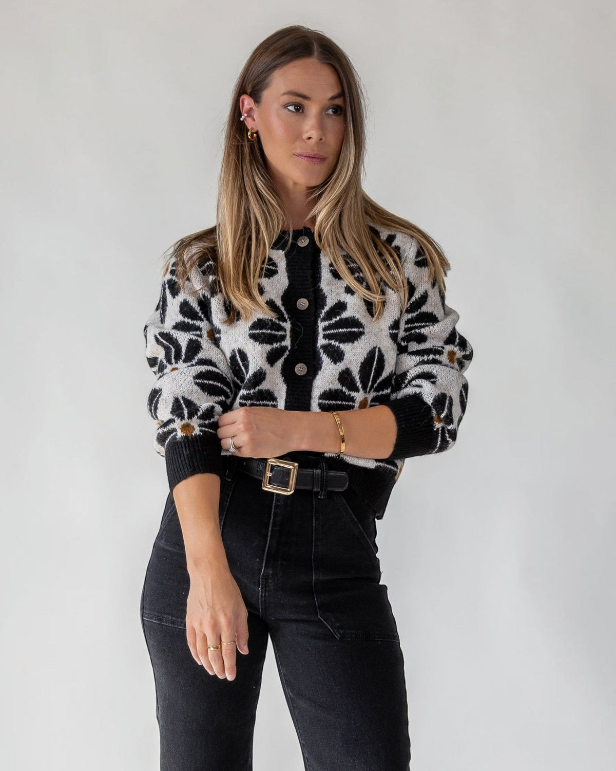Floral pattern worked across a plush black stretch knit cardigan