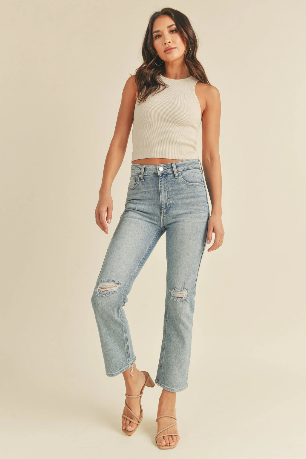 Distressed slits placed at each knee of a straight leg jean