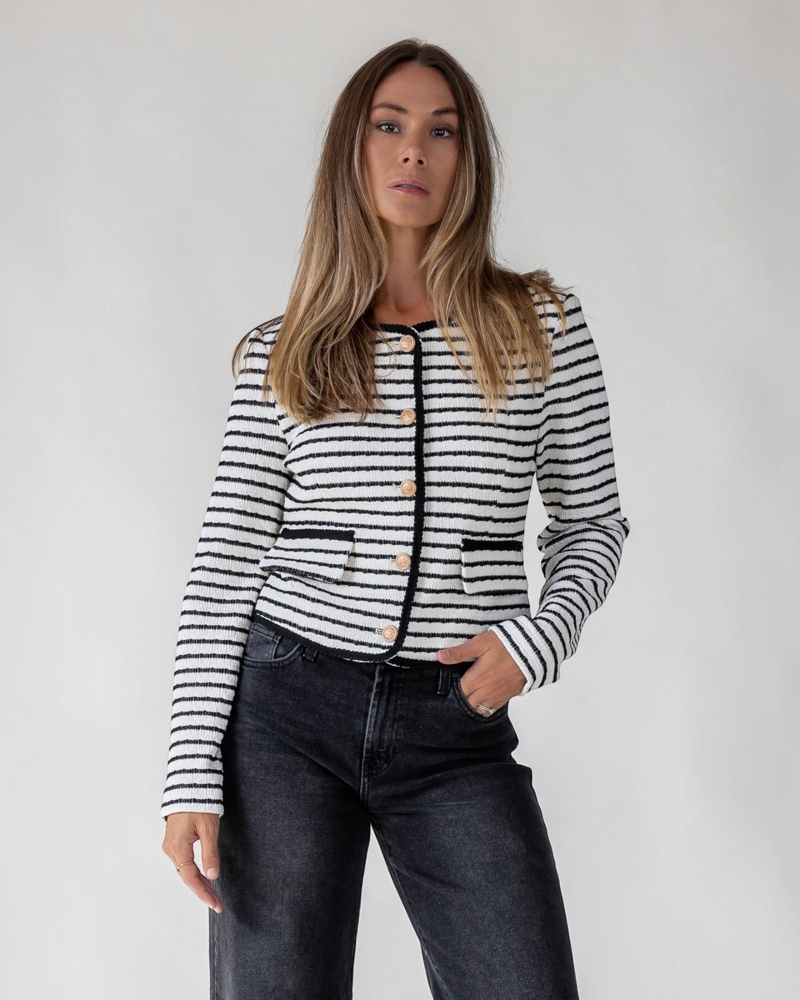Gold button front with contrast trim on a white striped knit top