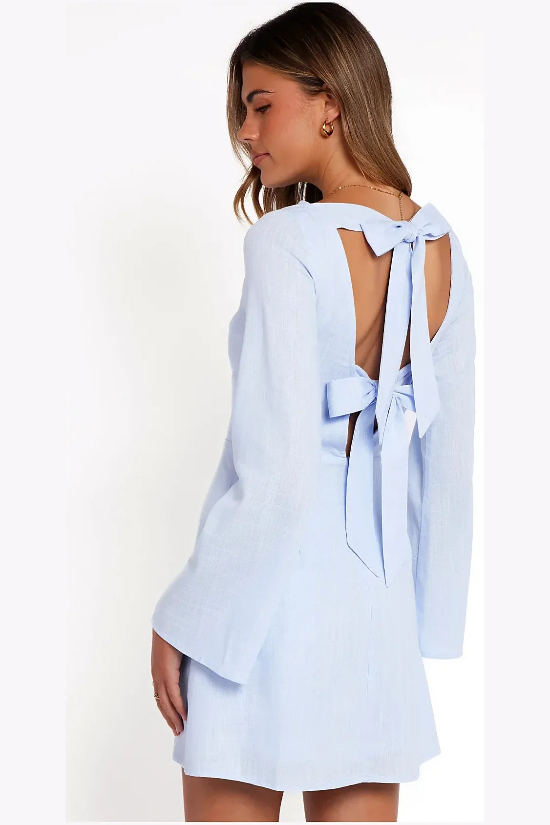Side view of a short periwinkle blue dress with flared sleeves