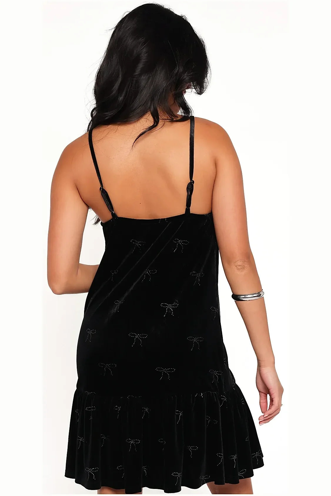 Close-up of the rhinestone bow on the black velvet dress