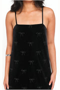 Black velvet mini dress with a rhinestone bow, front view