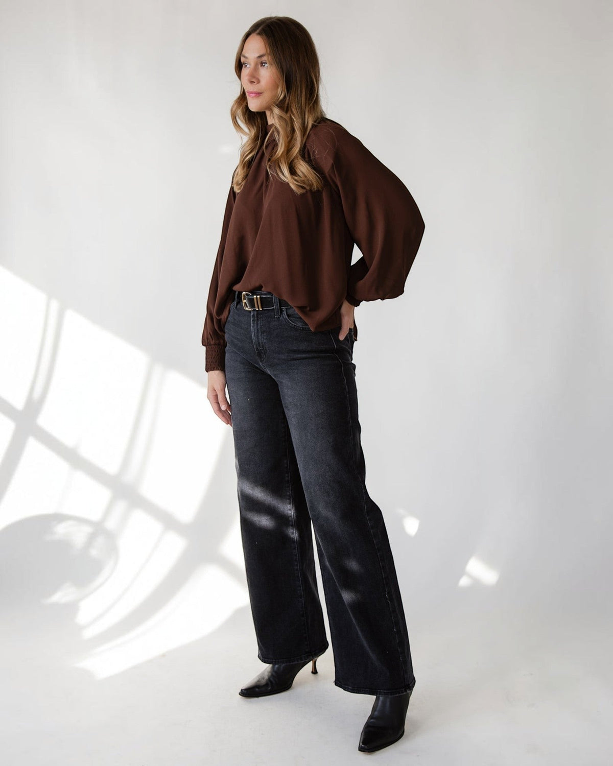 Long balloon sleeves finishing at smocked cuffs on a brown top