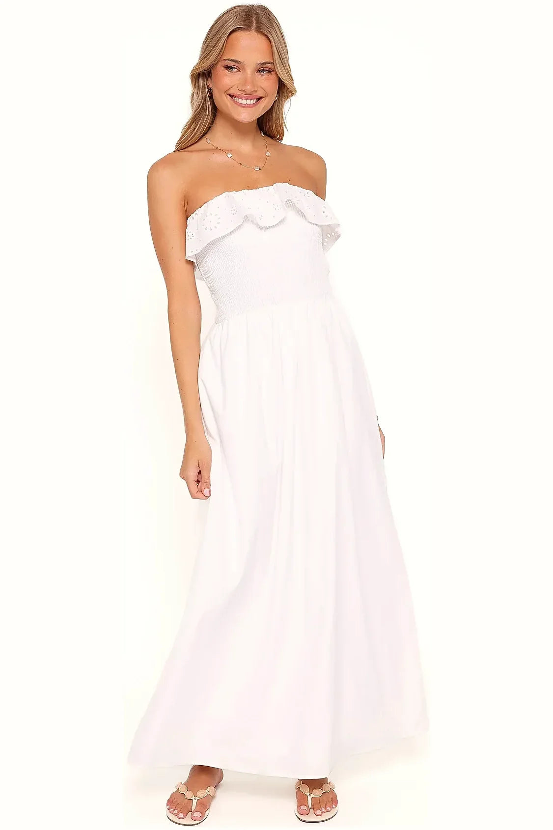 Long white strapless dress shown from the side