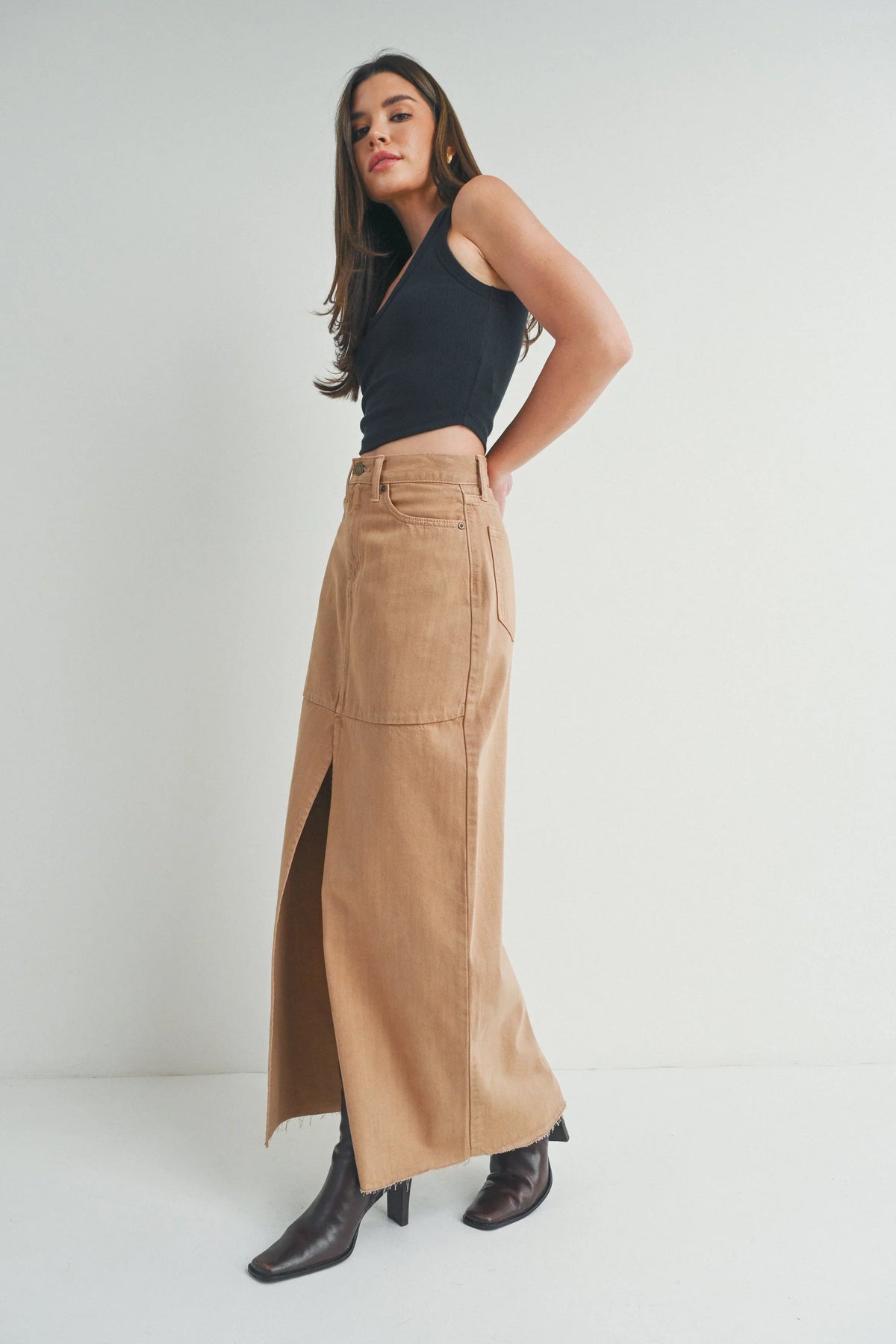 High rise waist cinching above a flowing denim skirt