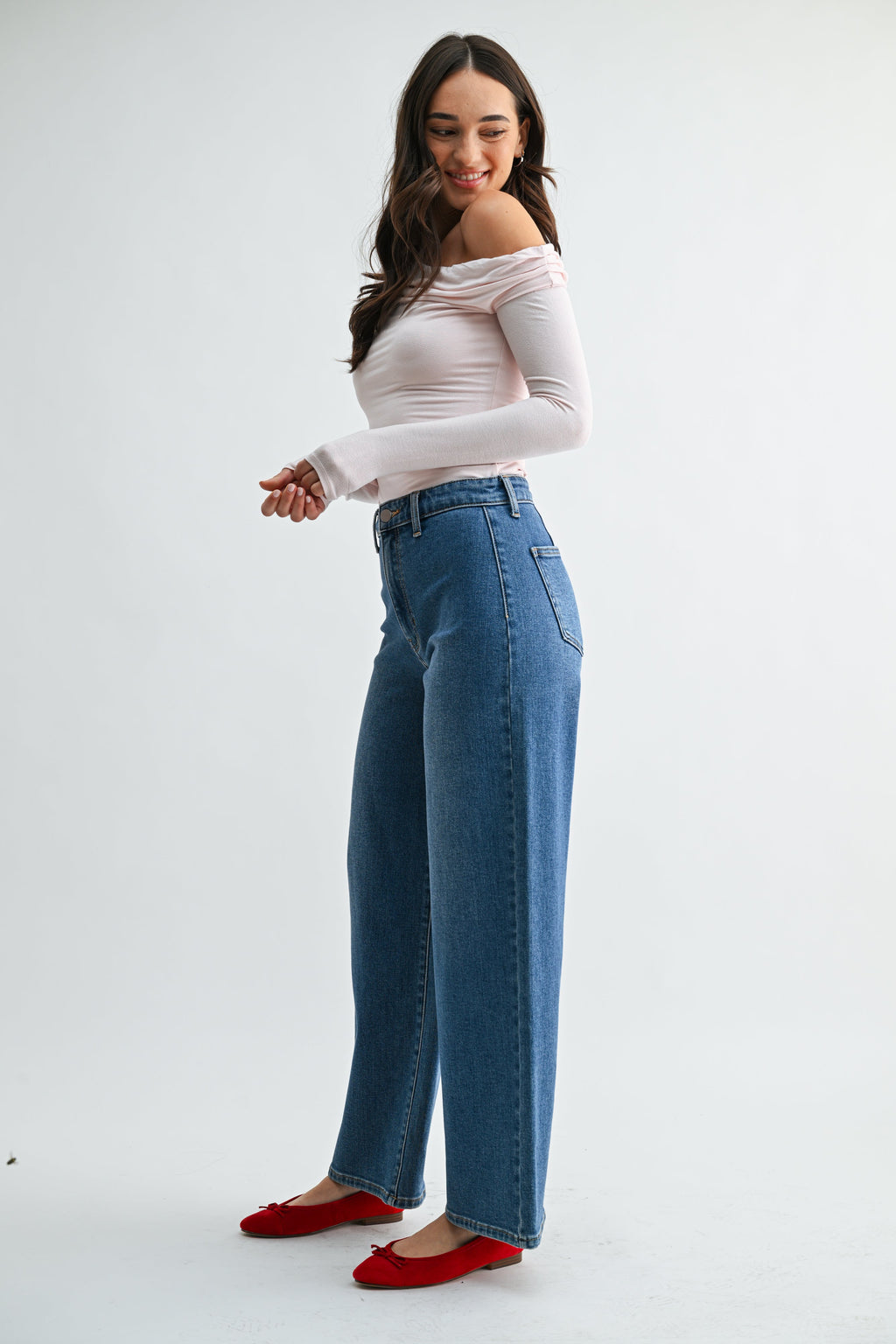 Hidden front pocket keeping the front of a black jean flat