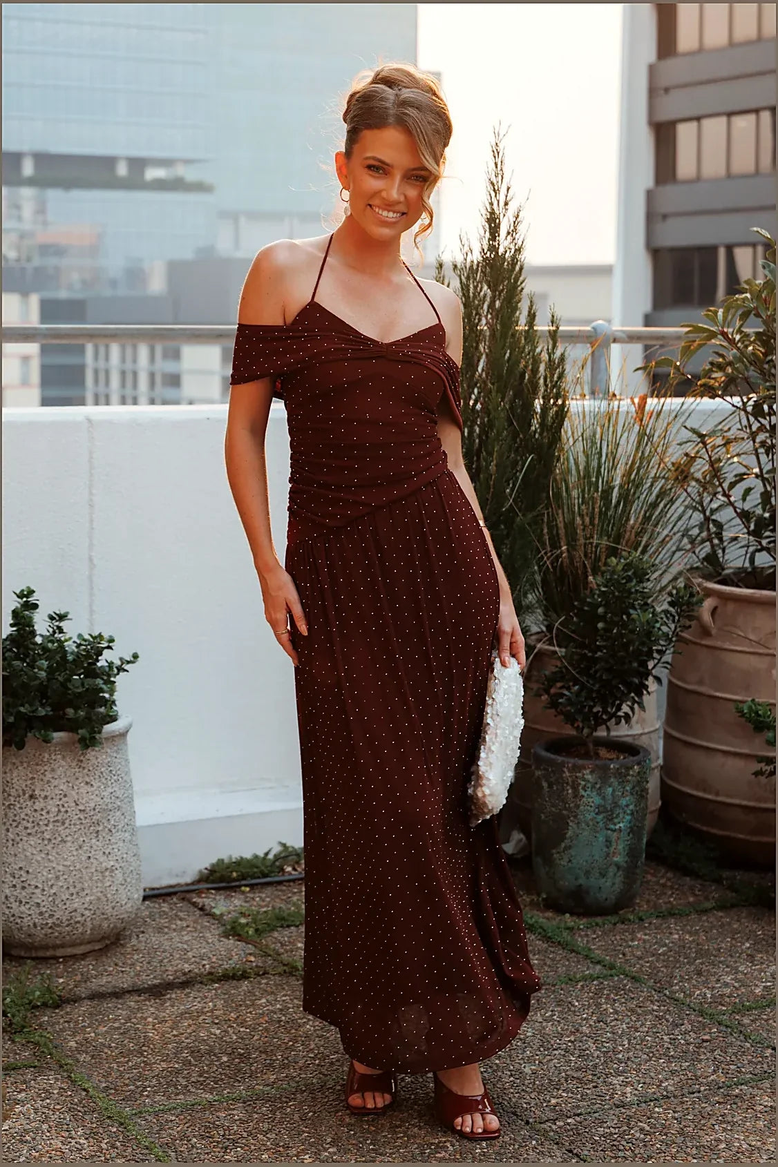 Full-length view of the burgundy halterneck maxi dress