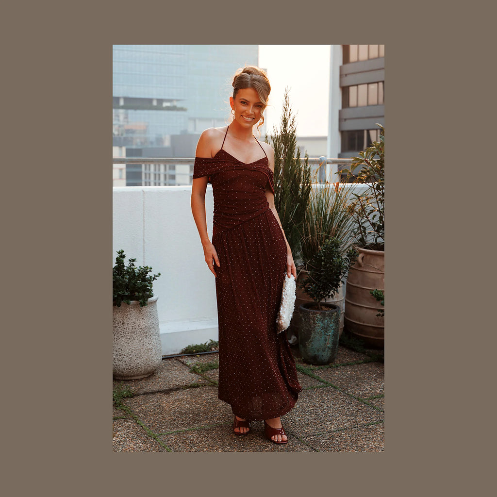 Long burgundy polka dot dress with short off-shoulder sleeves
