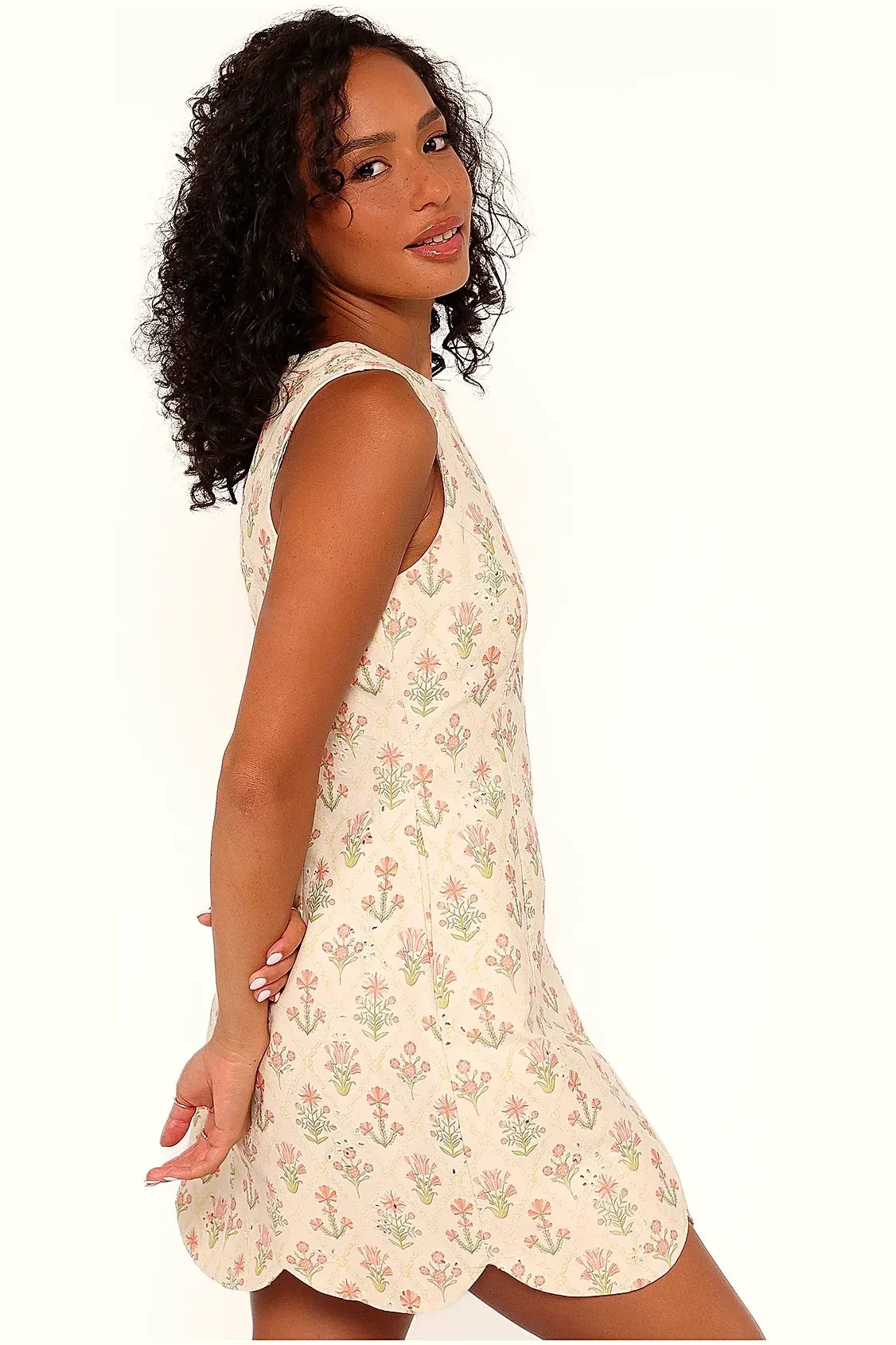 Coral floral mini dress shown from a three-quarter angle
