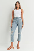 Raw unfinished hem at the ankle of a cropped jean