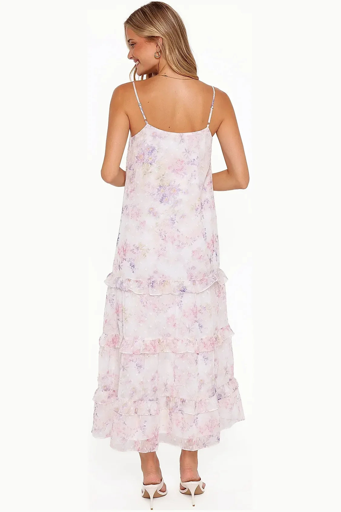 Close-up detail of the floral print on the white maxi dress