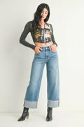 Cuffed hem turning up at the base of a wide-leg jean