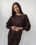 Wide boat neckline running shoulder to shoulder on a brown rib-knit sweater