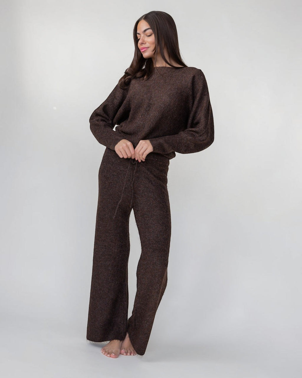 Brown rib-knit sweater with a polished drape and an off-shoulder neckline