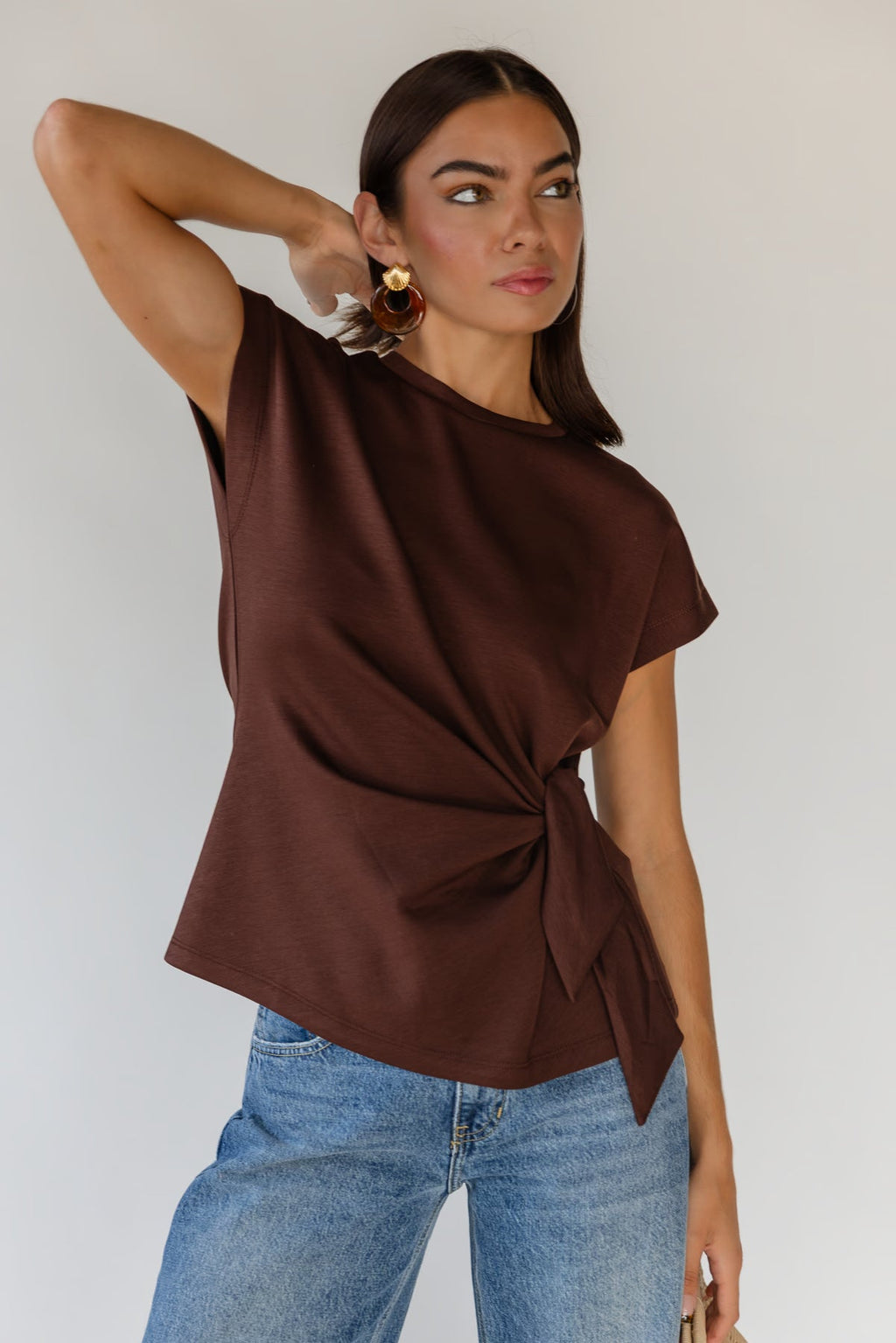 Chocolate brown knit top with a self-tie knot gathered at one side of the waist