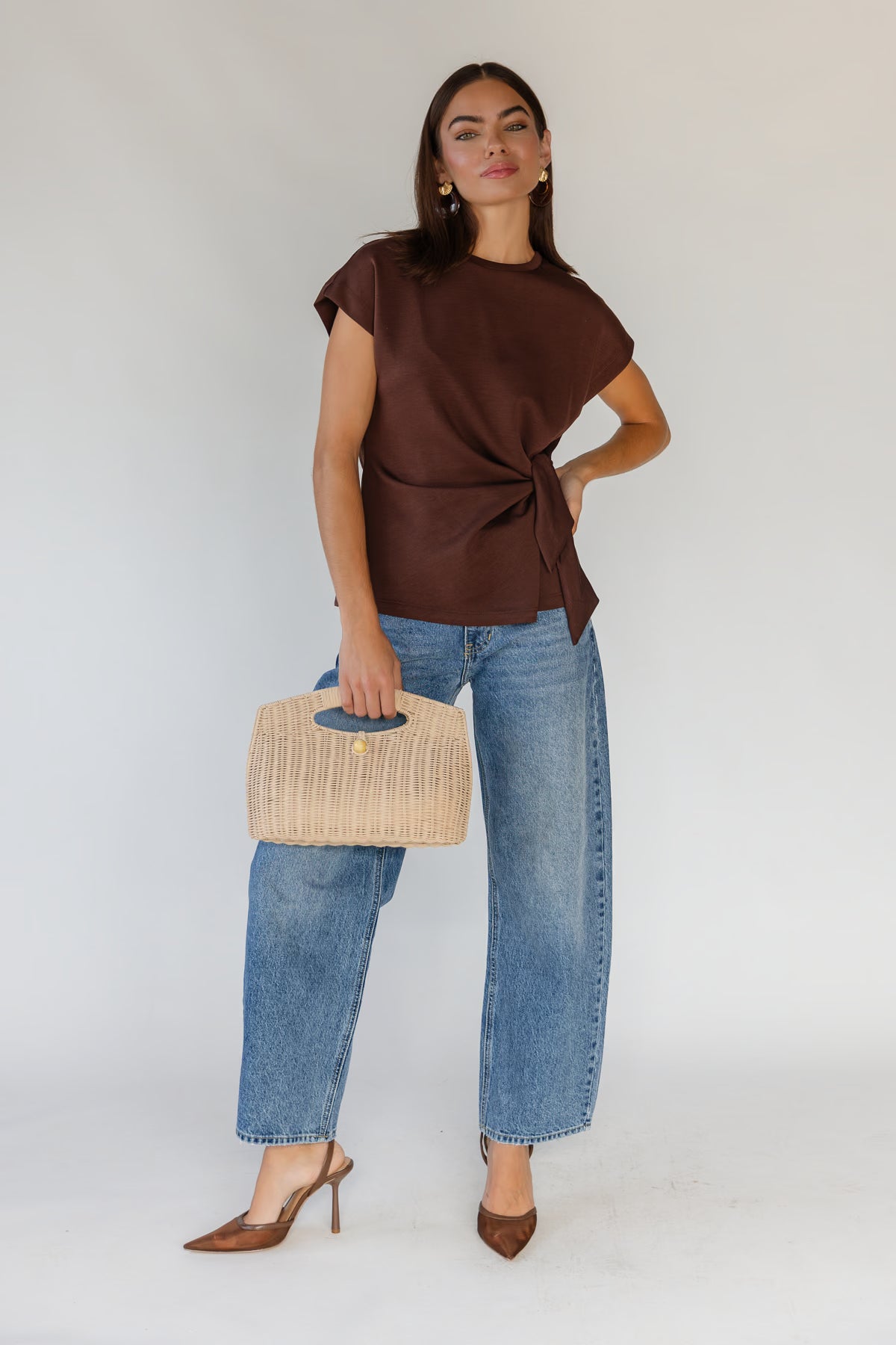 Round neckline with a clean minimal finish on a lightweight brown knit top
