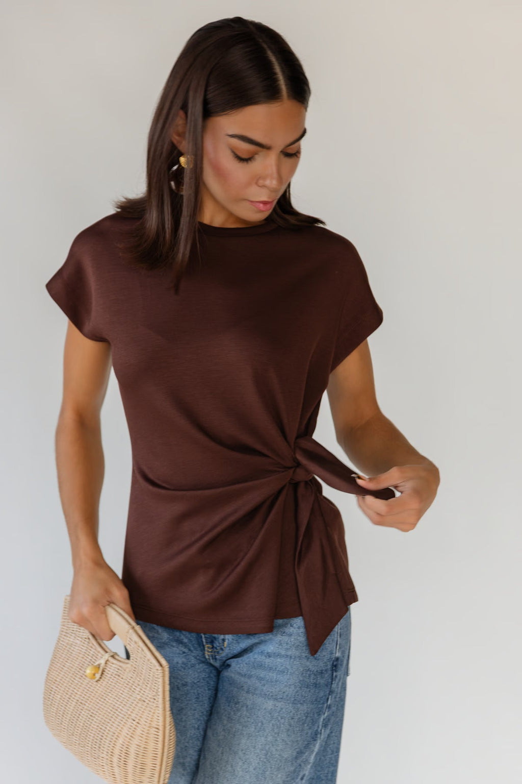 Cap sleeves and a relaxed body on a soft-draping brown knit top
