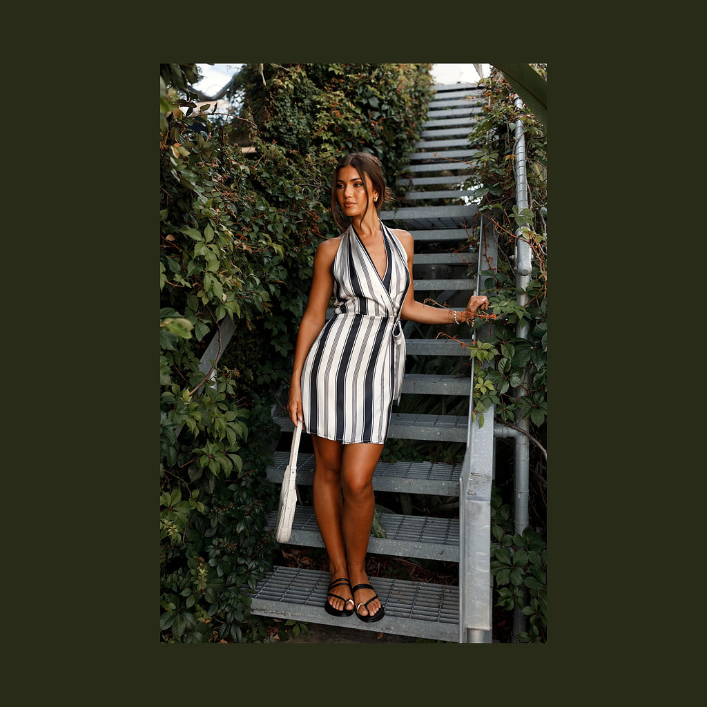 Black and cream wrap mini dress with a halter V neckline