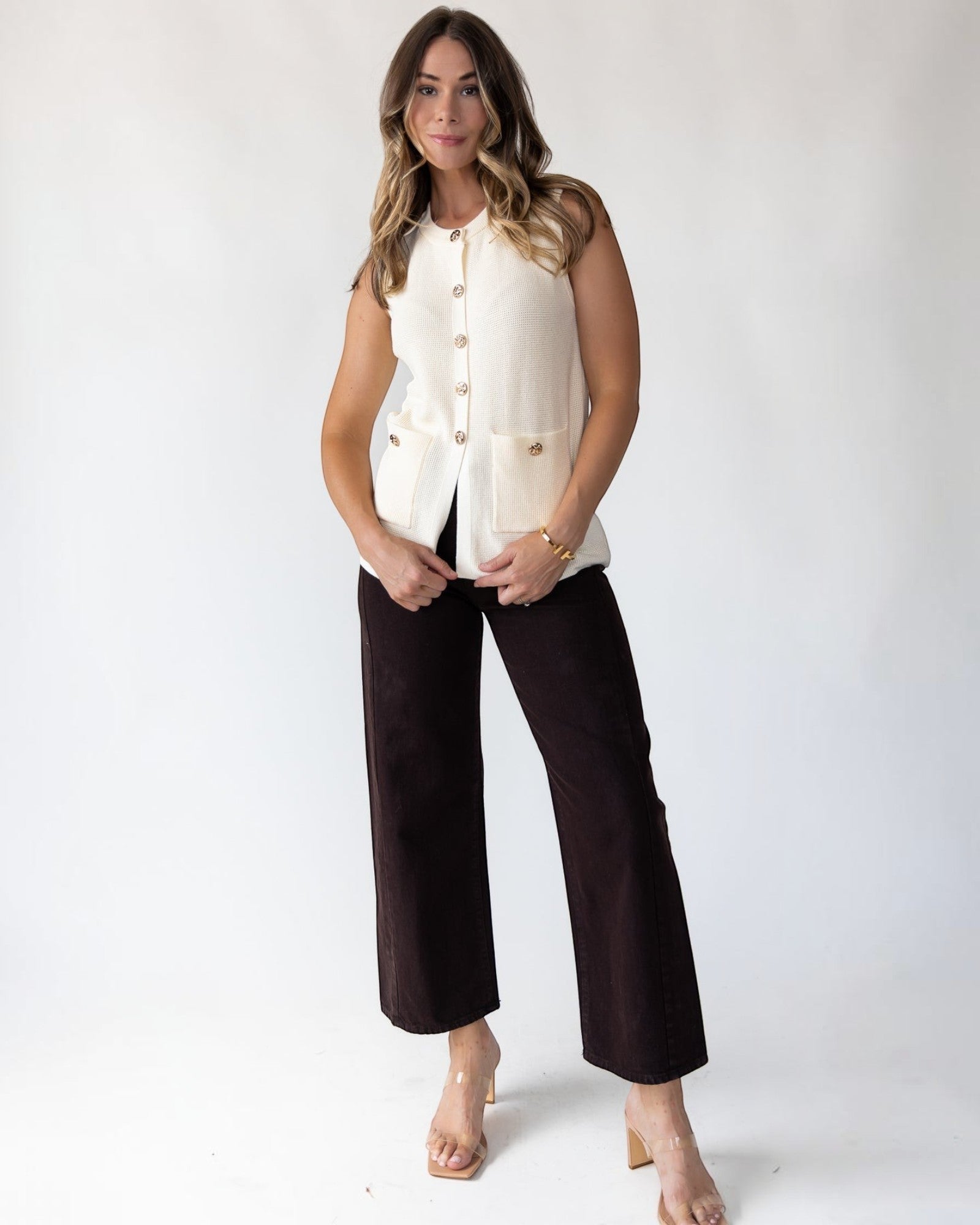 Front patch pockets on a midweight cream sleeveless knit