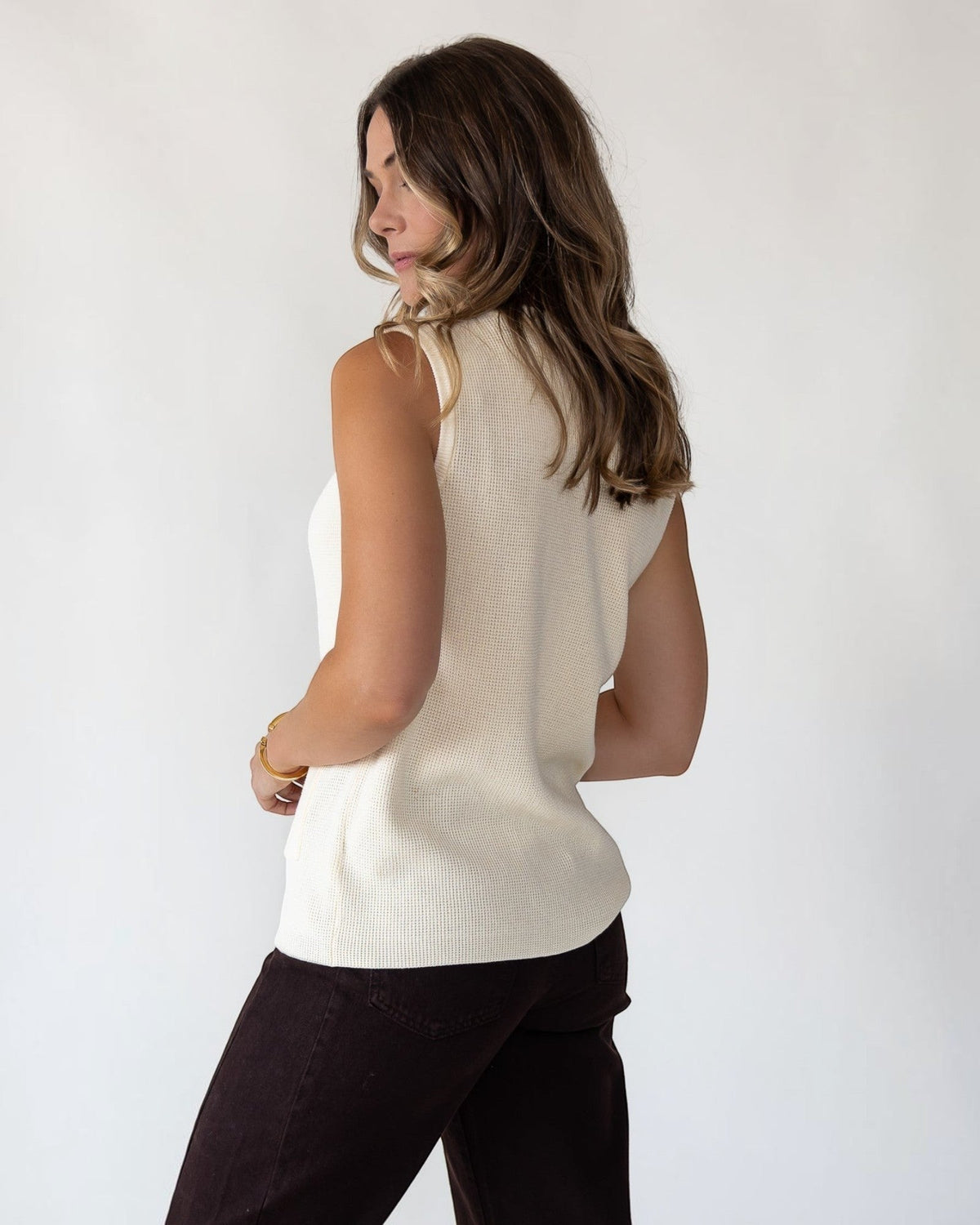 Hip-length hem on a softly structured cream knit layer