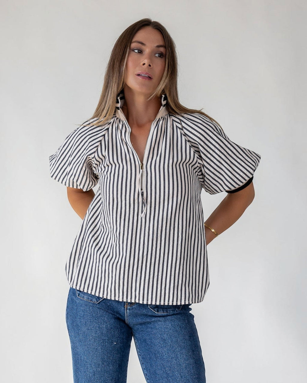 Multicolour ribbed band collar above a half-zip front on a striped top