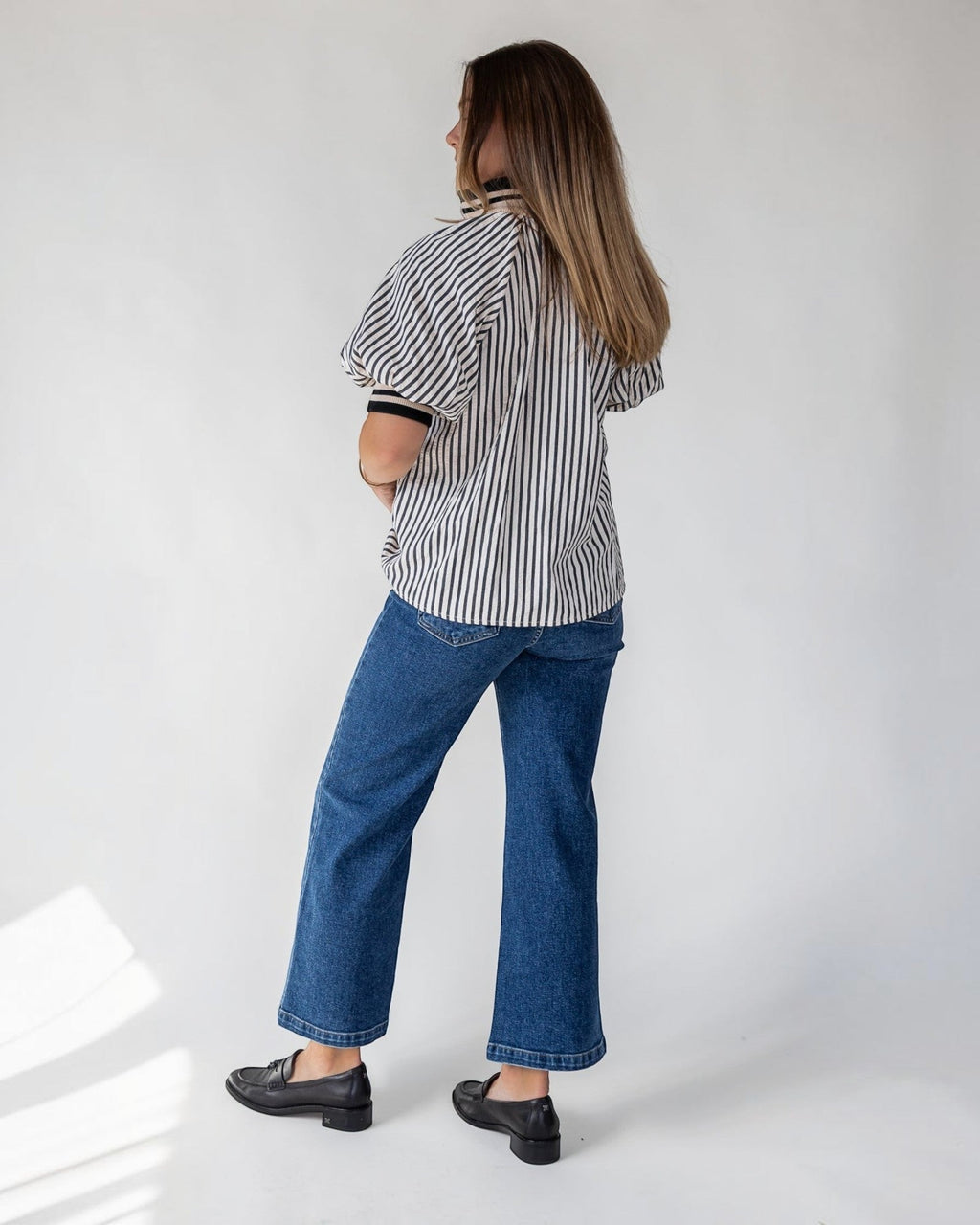 Short puff sleeves adding shape at the shoulder of a black striped top