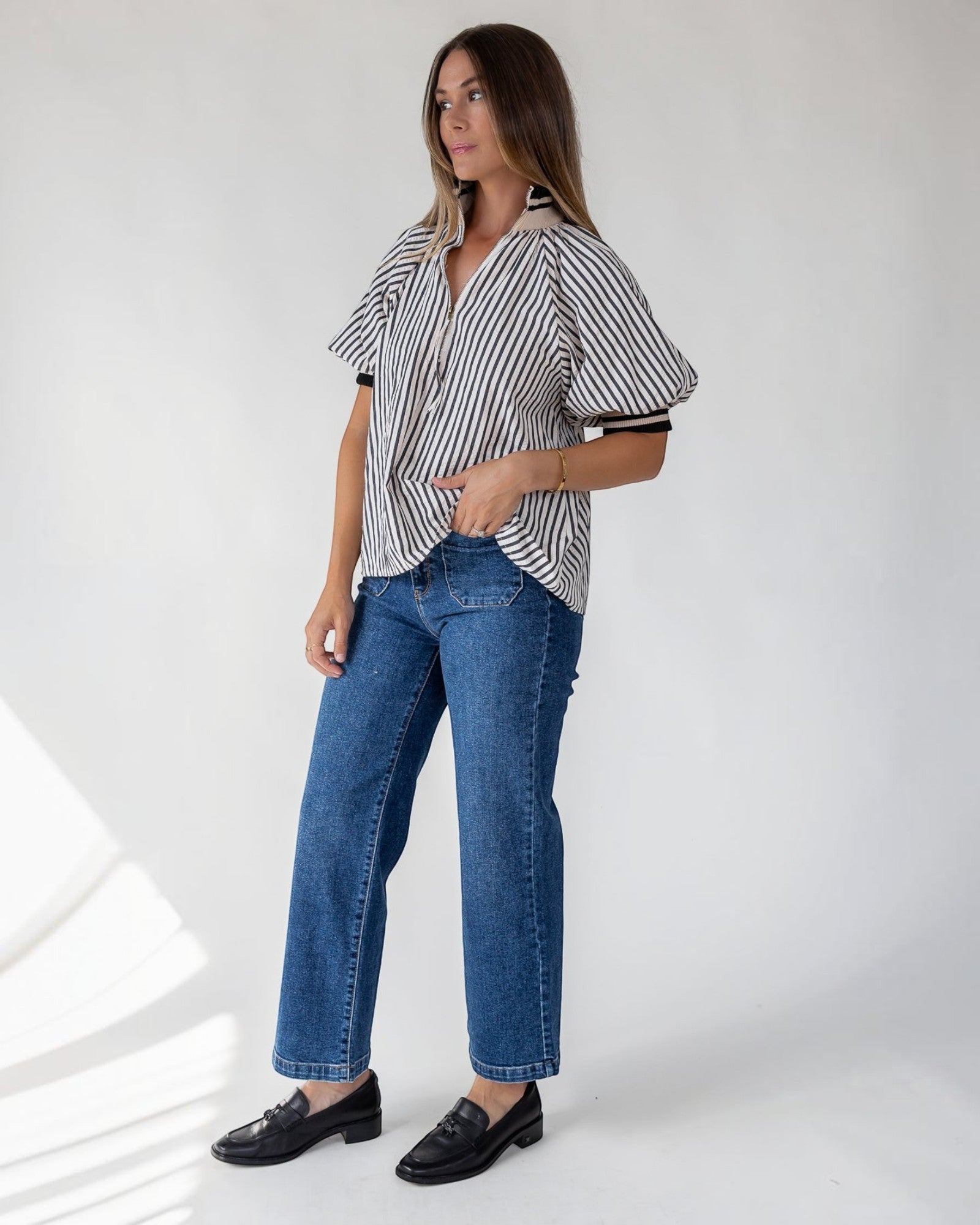Half-zip opening at the neckline of a lightweight striped top