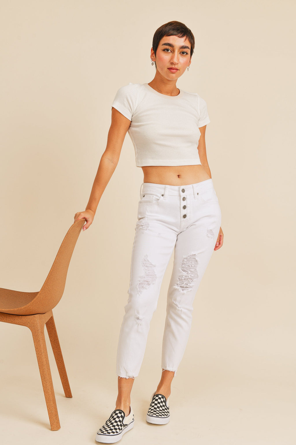 Four-button fly running down the front of a white jean