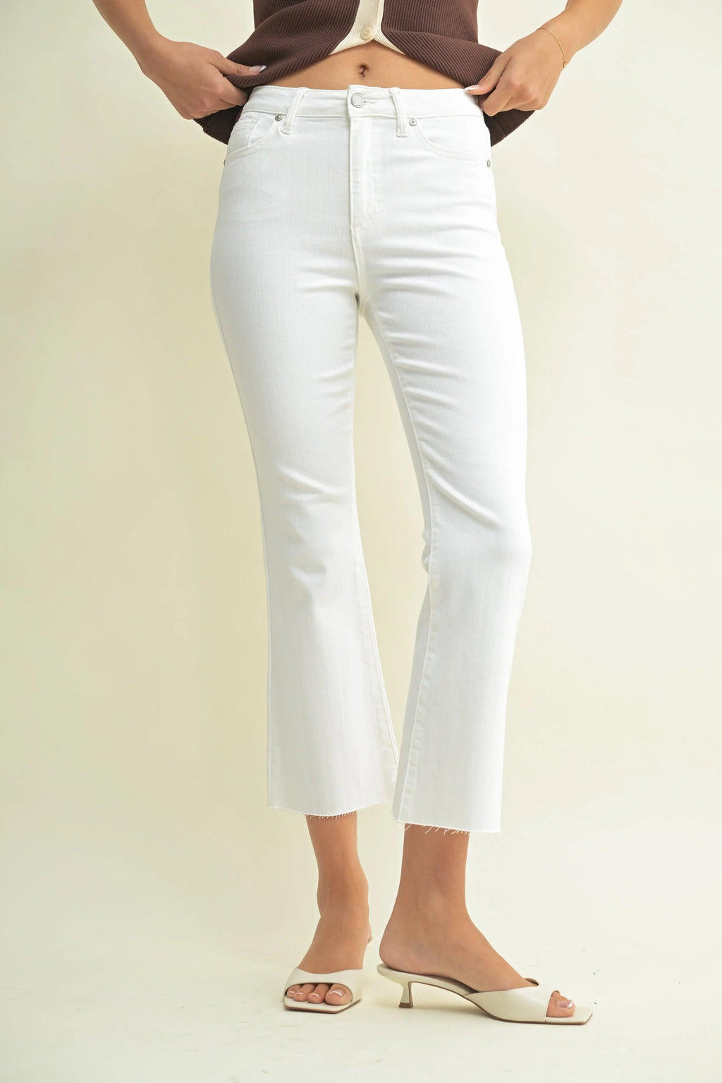 High rise waist on a cropped white kick flare jean