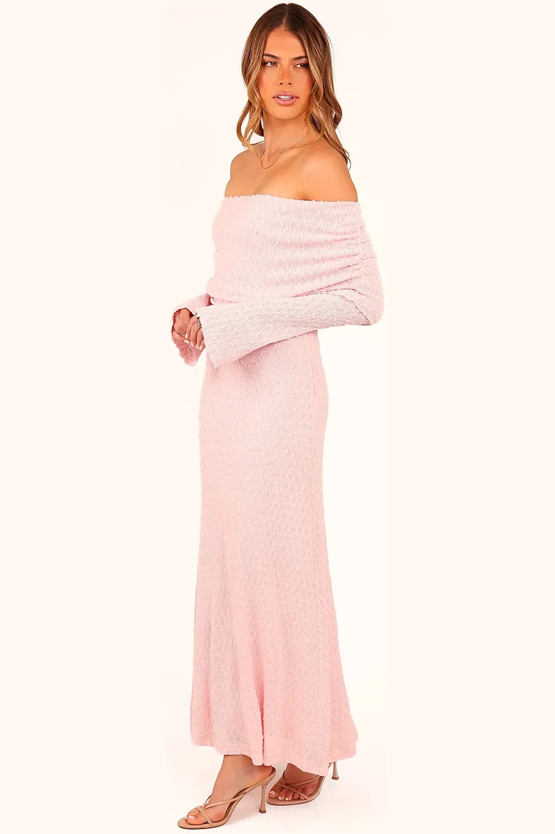 Detail of the off-the-shoulder neckline on the pink midi dress